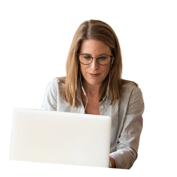 Woman with glasses using a laptop on a white background