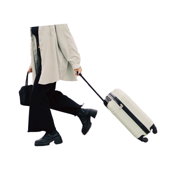 Person pulling a suitcase with a white background